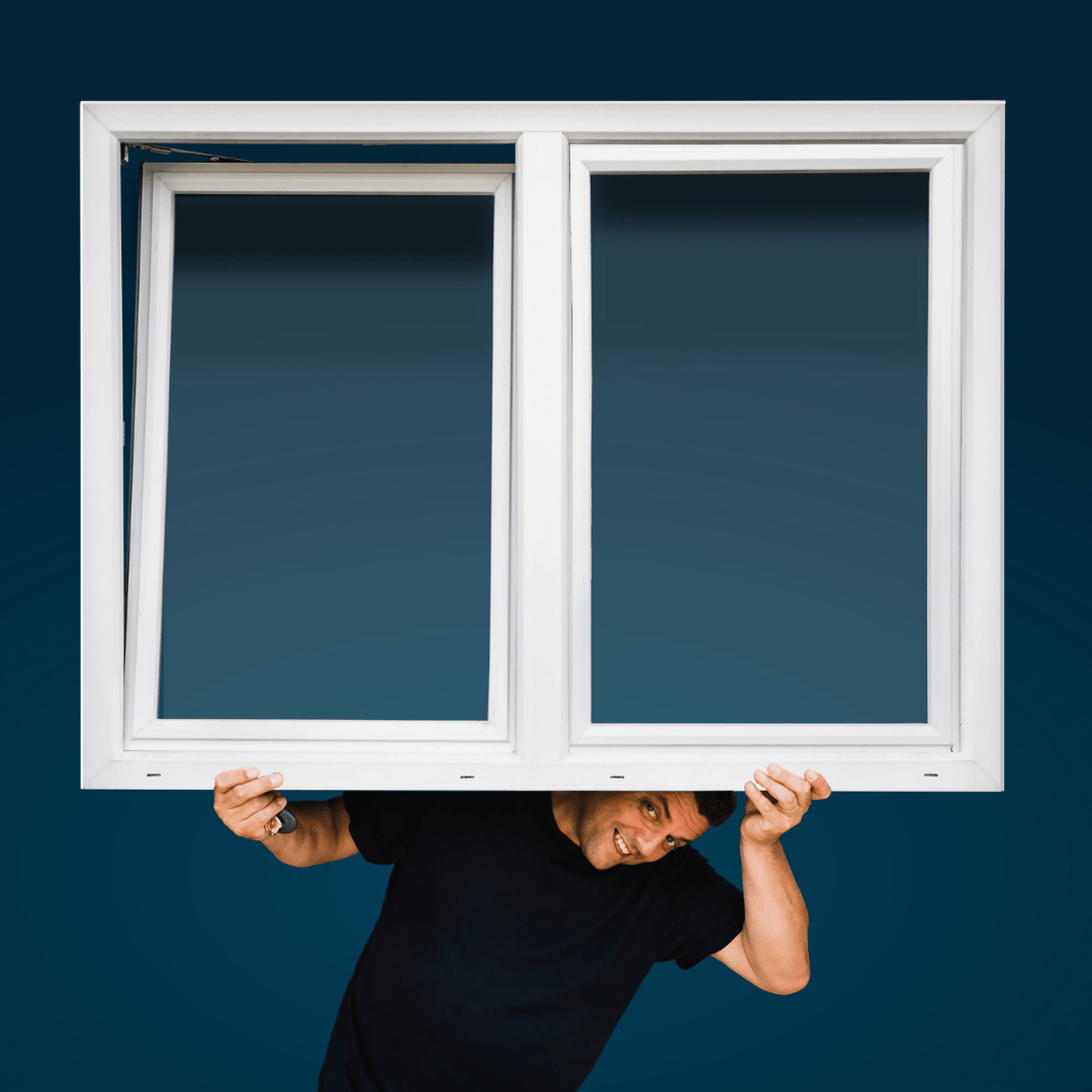 hombre que sostiene una ventana - instalaciones y subvenciones para ventanas